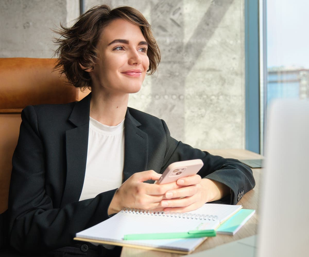 A professional reviewing finances on her phone